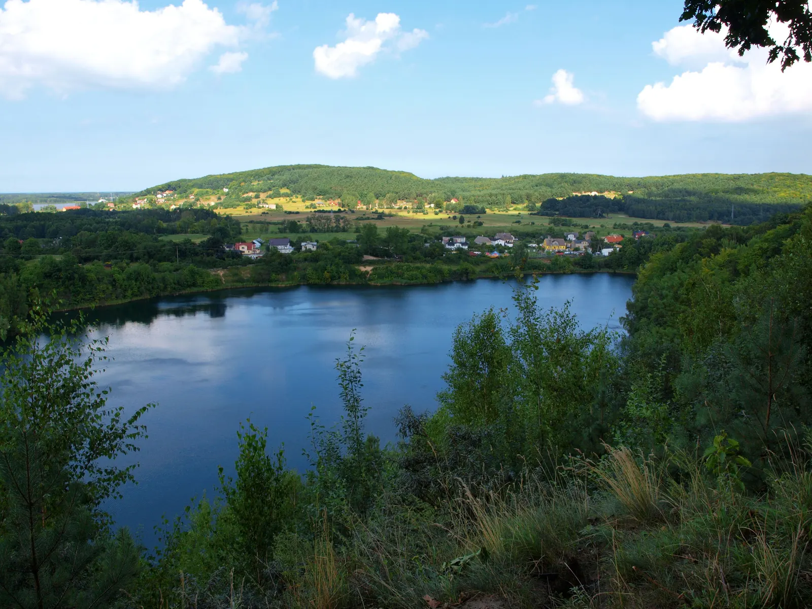 The turquoise water of the lake in a former chalk pit in Wapnica